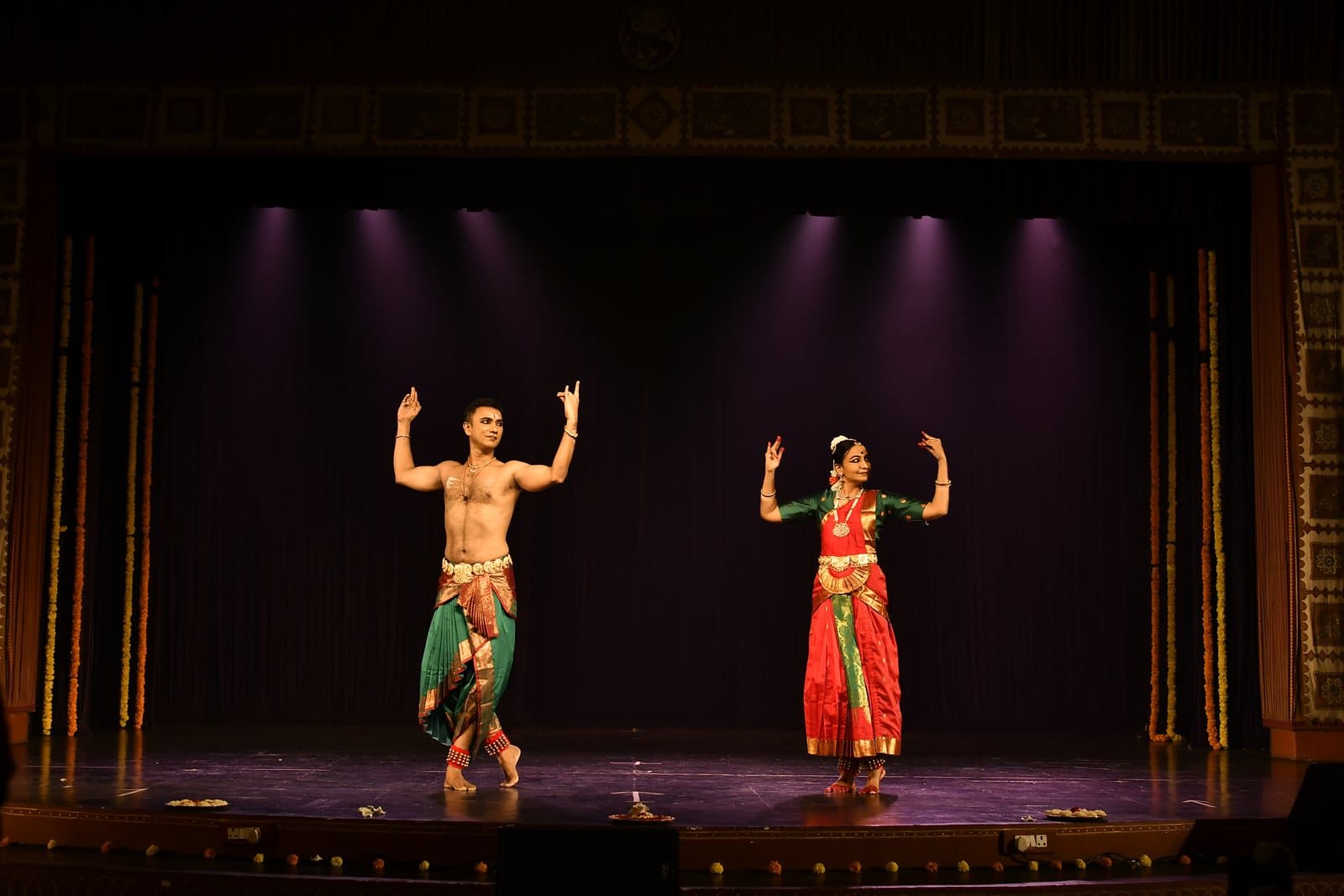 Two dancers mid-performance at Udaan 2025
