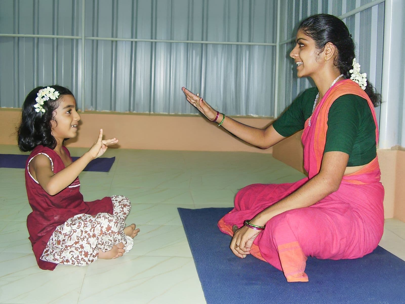A young student mirrors her teacher’s hand gesture in an early class, 2009