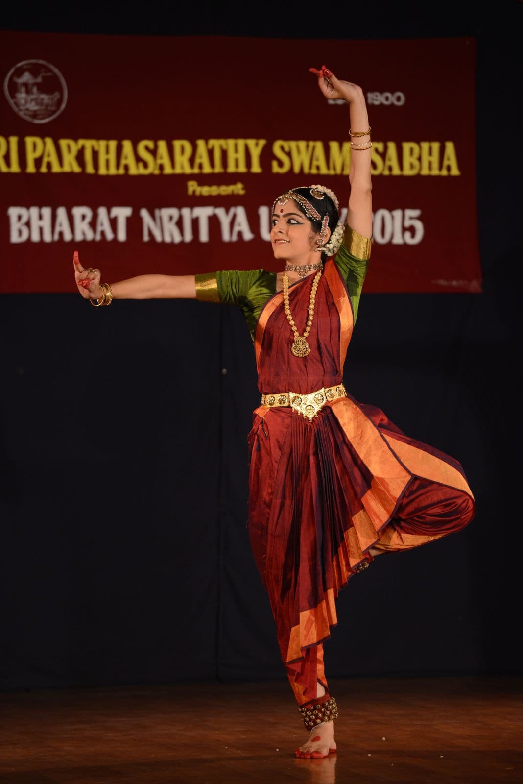 Sunitta Menghanaani on stage beneath the Sri Parthasarathy Swami Sabha Bharat Nritya Utsav banner, 2015