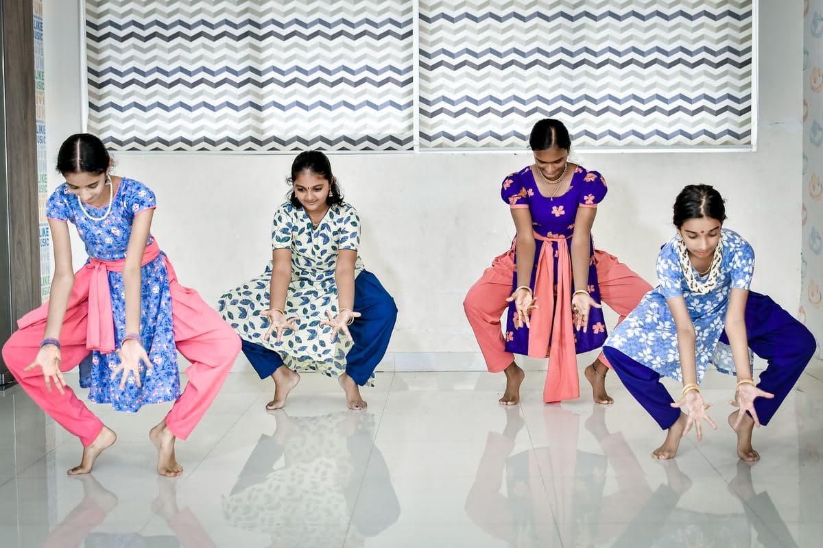 A Level 2 batch at Adroit, four students in a deep seated stance with their hands forward